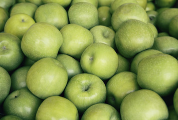 Fresh green apples close up at the market. Healthy food background concept