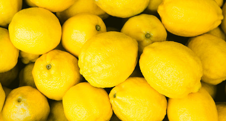 Fresh yellow lemons at the market. Food background