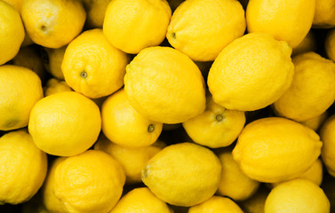 Fresh yellow lemons at the market. Food background