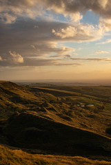 Obraz premium The view over the peak district and Manchester at sunset from the top of Coombe's Edge