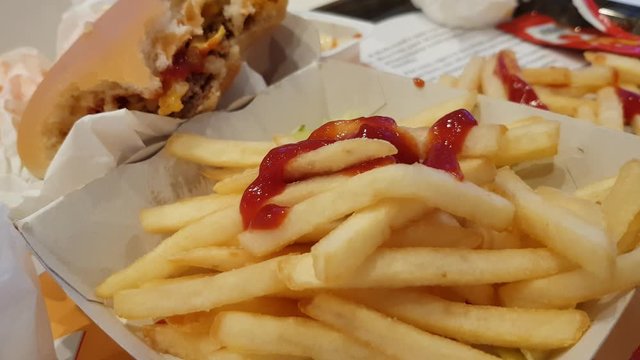 Dipping a french frie in ketchup sauce