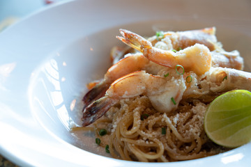 Spicy Spaghetti shrimp, italian food, white plate.