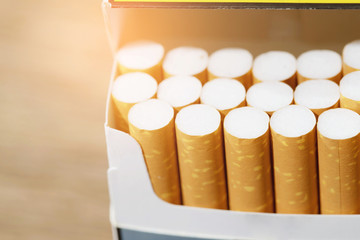 peel it off Cigarette pack prepare smoking a cigarette. Packing line up. photo filters Natural light. soft focus. tobacco, Leave space to write descriptive text.