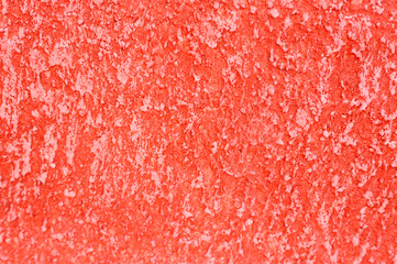 Rough texture of abstract decorative red background of plaster wall.