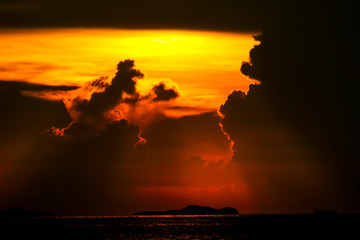 Fototapeta na wymiar colorful of sunset ray on cloud sky fishing boat on island and sea