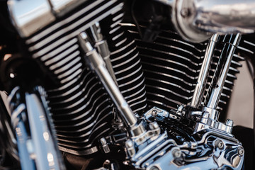 Rivne, Ukraine - September 23, 2019: Harley-Davidson Fat Boy motorcycle detail.  Motorcycle engine exhaust pipes. Close up of a classic motorcycle with lots of chrome details.