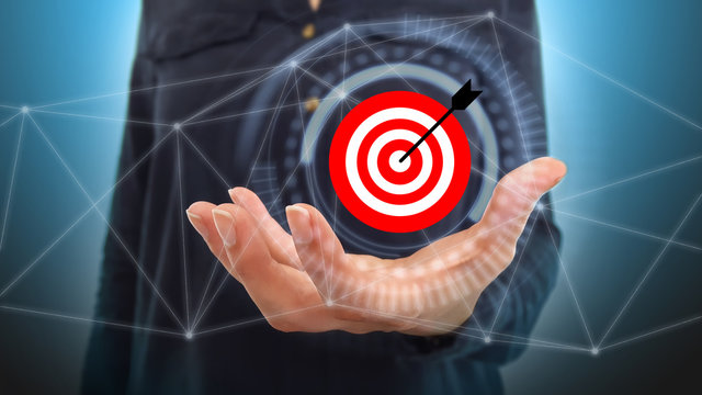 Businesswoman on blurred background using digital target and arrow