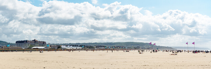 panorama of the expansive sandy beaches at Deauville in Normandy on a beautiful summer day