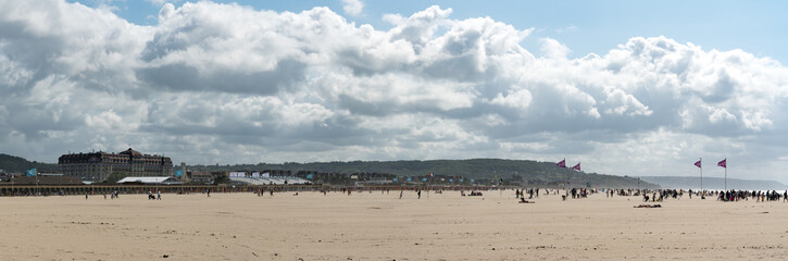 Fototapeta na wymiar panorama of the expansive sandy beaches at Deauville in Normandy on a beautiful summer day