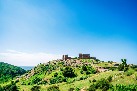 Ruin of a castle on the top af o green hill