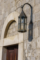 wall of a building with a fixed lantern in the medieval fortress of the city of Bar