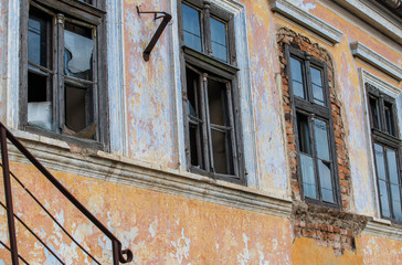 Fototapeta na wymiar Broken windows on old abandoned residentual house in Transylvania, Romania.