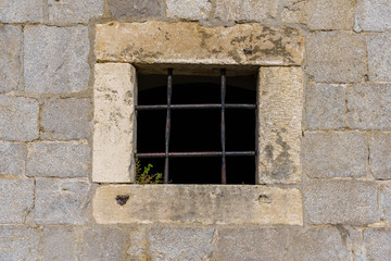 Fototapeta na wymiar window of a building with bars in the medieval fortress