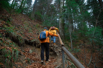 Fototapeta premium couple friends hiking by forest mountains