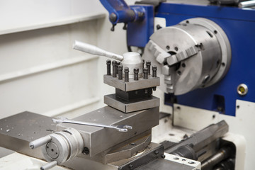 Lathe for metal processing in a workshop. A modern lathe for processing metal and other materials.