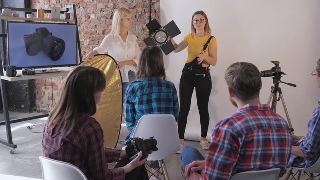 photo equipment, during a master class in studio photography teacher talks about working with studio lighting to young photographers