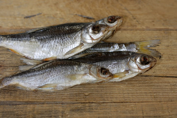 Close-up dried river fish on old wooden background.