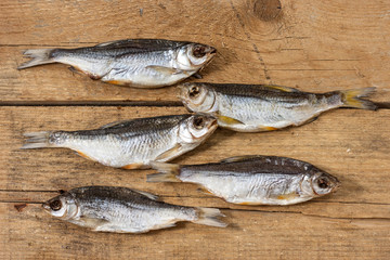 Close-up dried river fish on old wooden background.