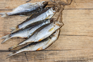 Close-up dried river fish on old wooden background.