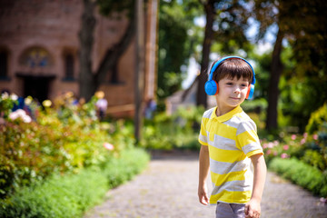 Stereo sound. Child boy autumn outfit enjoying music. Little kid listening music enjoy favorite song excellent sound. Good vibes only. Awesome sound. boy kid with headphones urban background