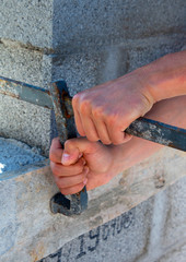 male and female hands with building materials