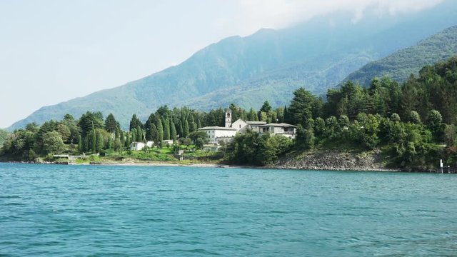 Landscape shot on Lake Como with Piona Abbey in the woods