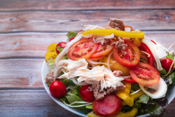 Fresh healthy salad on wooden table. Top view with copy space
