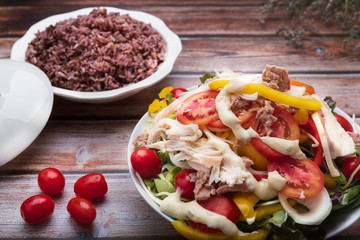 Fresh healthy salad on wooden table. Top view with copy space