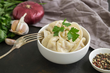 Russian dumplings in a white plate on a black background