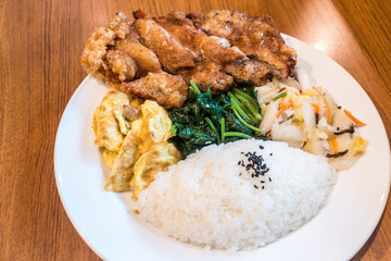 Taiwanese food gourmet fried chicken with rice , bento/boxed meal in wood background