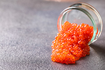 Salmon  Red Caviar in a white plate on a dark background. Healthy Food Concept. Snack.Copy space for Text.Seafood.