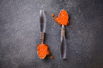 Salmon  Red Caviar in a white plate on a dark background. Healthy Food Concept. Snack.Copy space for Text.Seafood.