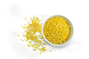 Top view of Hulled split mung bean in White cup on white background