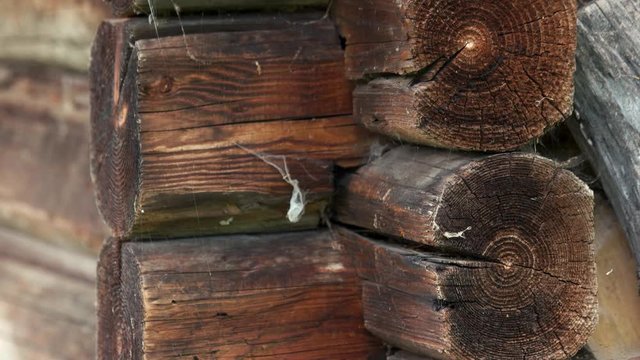 Old wooden balk wall background. Weathered balk wall construction close up.