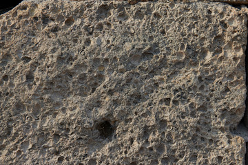 rough sandy texture of an old medieval stone wall. Background for design, close-up, copy space