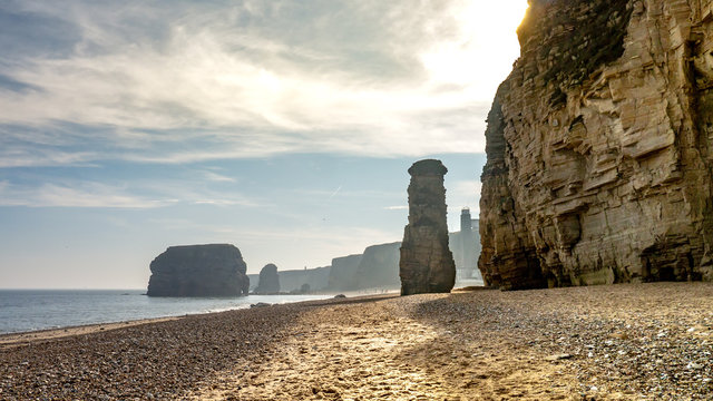 Marsden Beach/Bay located in South Shields near Sunderland.  Beach is located next to a limestone rock cliff face (the Leas), showing sandy beach, rocks, sea and eroded cliffs.