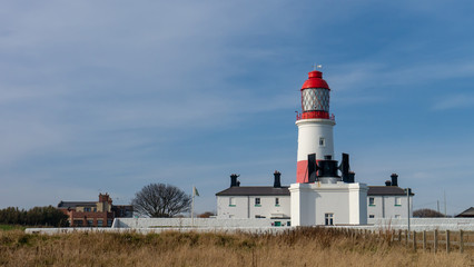 Fototapeta na wymiar Souter Lighthouse and The Foghorn, South Shields, Tyne and Wear, England UK. Taken in the morning with blue sky background.