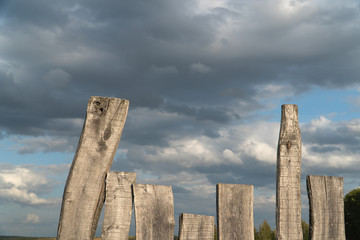 old wooden gray natural planks on a background of blue sky and white clouds