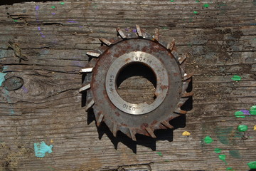old used gears on a wooden background