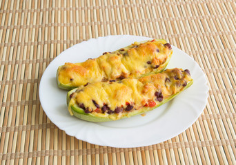 Zucchini boat with chicken, beans and vegetables under cheese