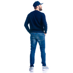 Man in jeans shorts, cap, casual clothing standing looking on white background isolation, rear view