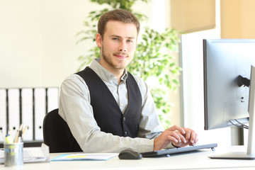 Fototapeta premium Serious executive posing looking at camera at office