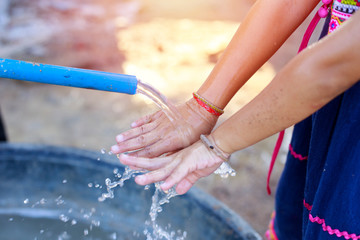 Children washing hands, children hands with clean water, children and nature concept