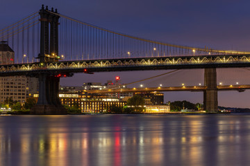 Fototapeta premium Brooklyn and Manhattan Bridges from East river at night with long exposure