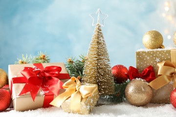 Presents and Christmas tree on decorated background, space for text