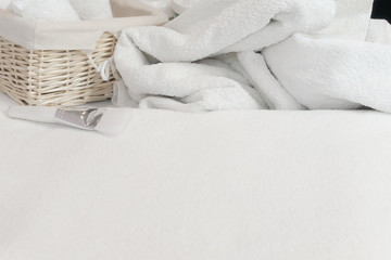 Fototapeta na wymiar Beauty studio background. White towel, basket and cream. Body and face care