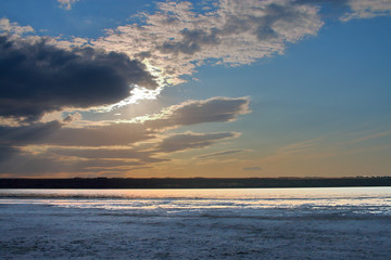 Cloudy sky over the dead coast of salty estuary.