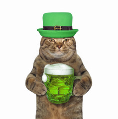 The cat in green hat with a mug of beer celebrates St. Patrick's Day. White background. Isolated.
