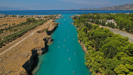 Aerial bird's eye view photo taken by drone of stand up paddle surfers in annual SUP crossing competition in Corinth Canal, Greece
