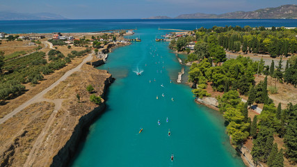 Aerial bird's eye view photo taken by drone of stand up paddle surfers in annual SUP crossing competition in Corinth Canal, Greece